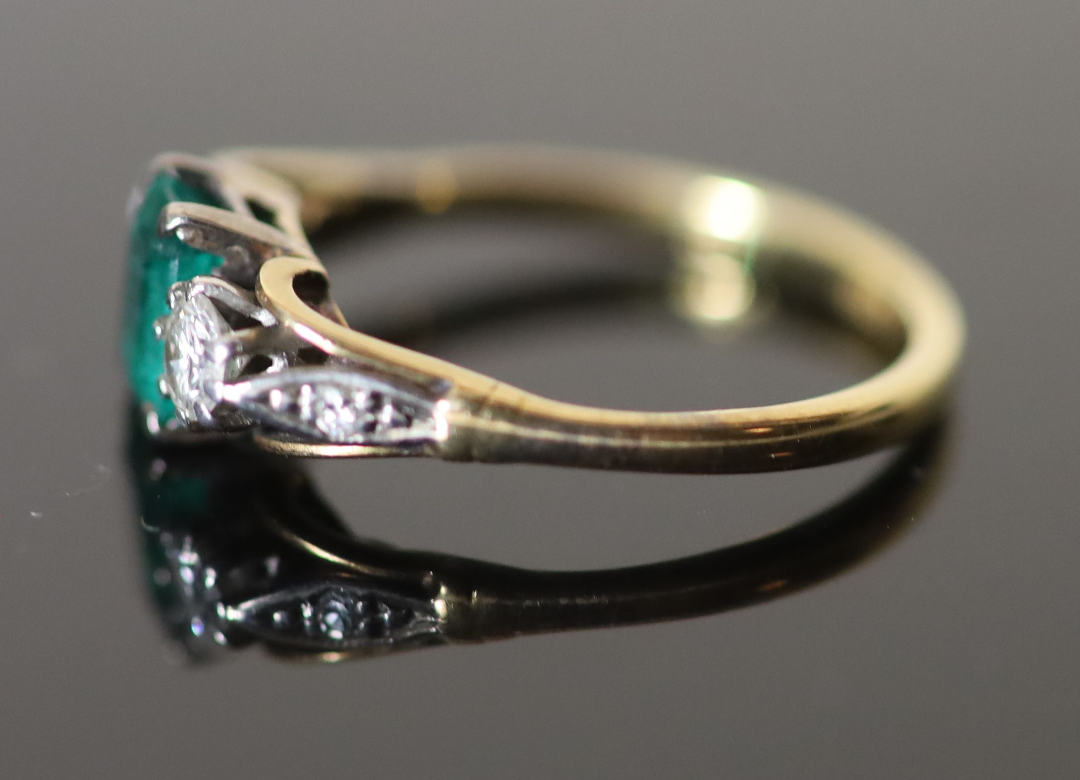 An 18ct gold, emerald and diamond set three stone ring,